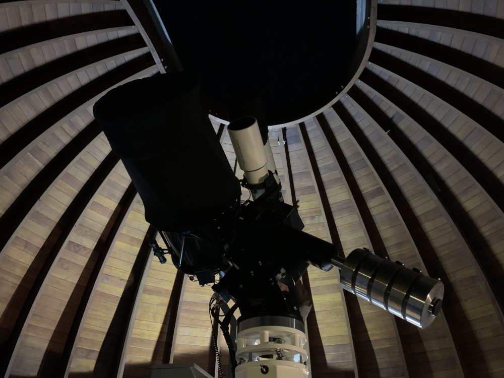 Innerhalb der Kuppel einer Sternwarte in der Nacht bei einer Himmelsbeobachtung mit Teleskop